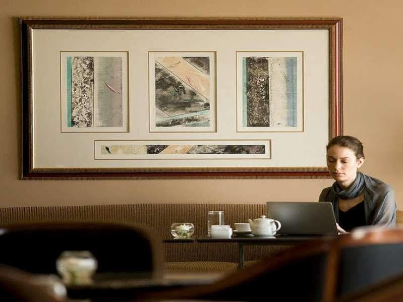 Bumi Surabaya City Resort Exterior photo A woman working at a Starbucks